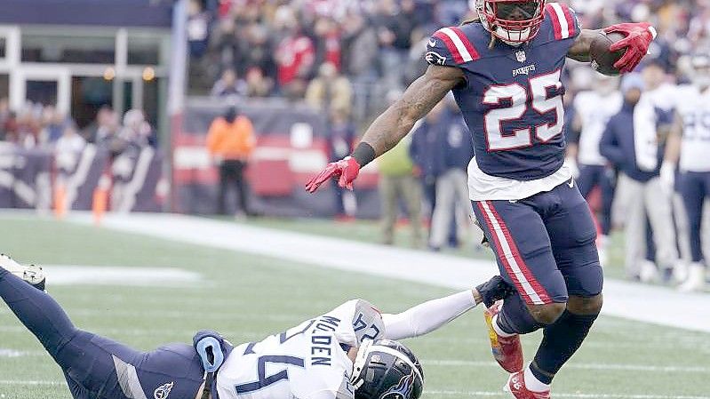 Brandon Bolden (r) befreit sich von Elijah Molden von den Tennessee Titans. Foto: Steven Senne/AP/dpa