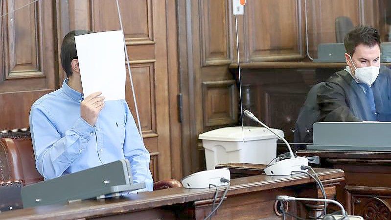 Der Angeklagte (l) sitzt neben seinem Anwalt Haydar Güler im Gerichtssaal im Strafjustizgebäude. Foto: Christian Charisius/dpa/Pool/dpa