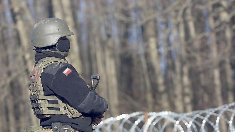 Ein bewaffneter polnischer Soldat bewacht in der Nähe des Ortes Usnarz Gorny die EU-Außengrenze zu Belarus. Foto: Doris Heimann/dpa