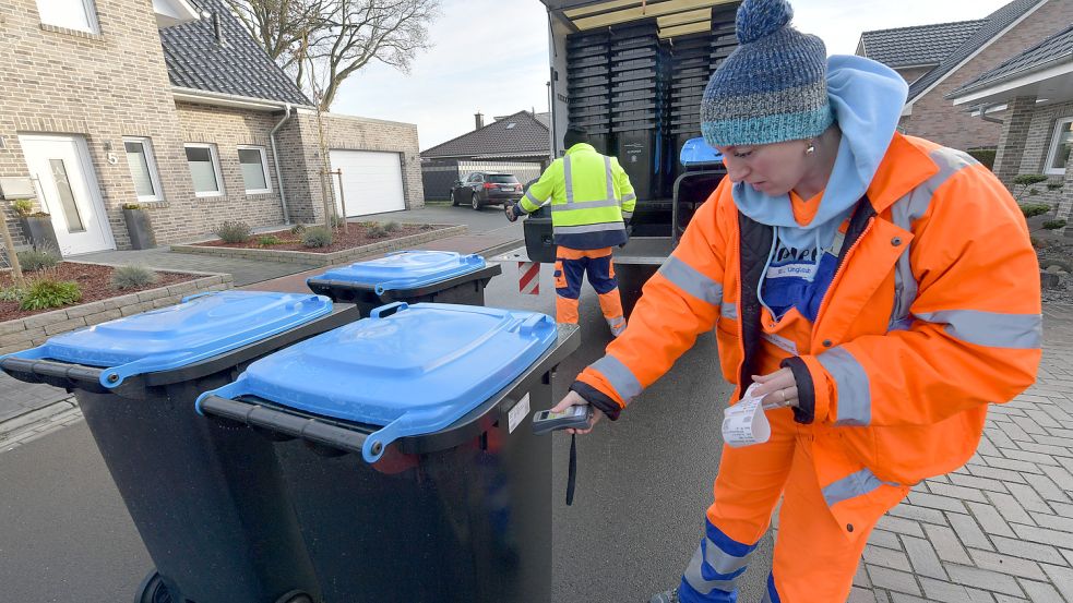 Marinella Moldovan scannt bei der Auslieferung der blauen Tonne den Code. Foto: Ortgies