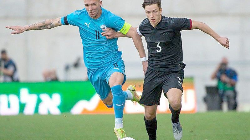 Noah Katterbach (r) kämpft gegen Israels Eden Karzev um den Ballbesitz. Foto: Berney Ardov/dpa