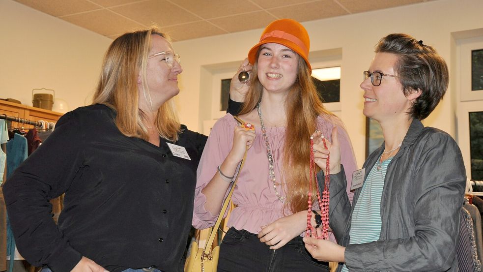 Stylingtipps gab es bei der Kleidertausch-Party auch: Hier verhelfen die Organisatorinnen Svenja Kaste (links) und Katharina Glaum (rechts) Ramona Kolossa zu Accessoires für ihr neues Outfit. Foto: Ullrich