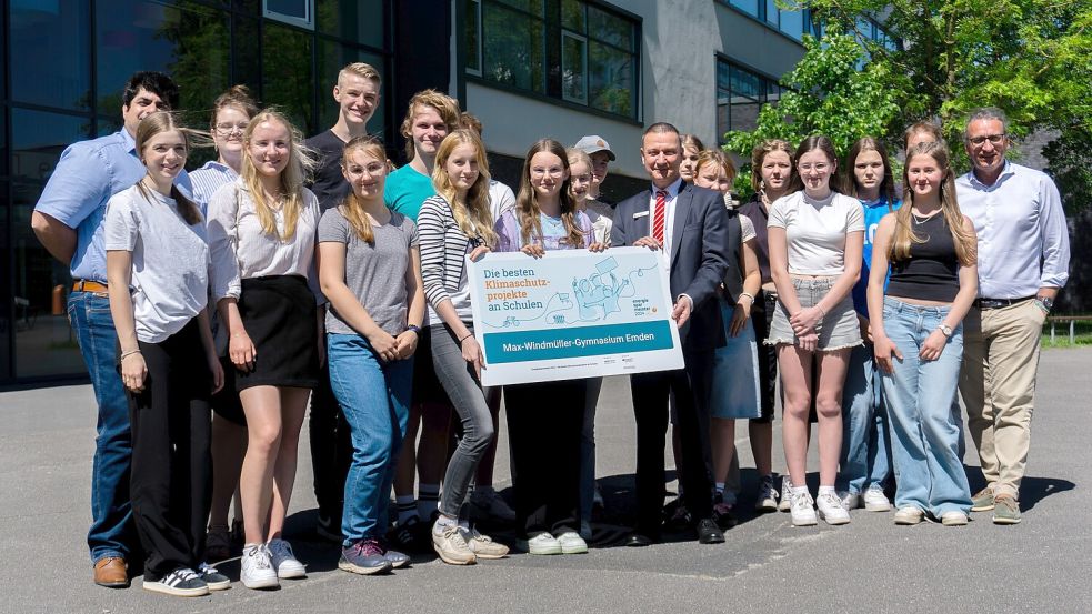 Niedersächsische Landesmeister sind sie schon. Die Gymnasiastinnen und Gymnasiasten vom Max freuen sich mit ihrem Paten Jens Jann (rechts am Plakat) über den Sieg im Energiesparmeisterwettbewerb. Jetzt hoffen sie darauf, beim Online-Voting für den Bundessieg zu punkten. Foto: privat