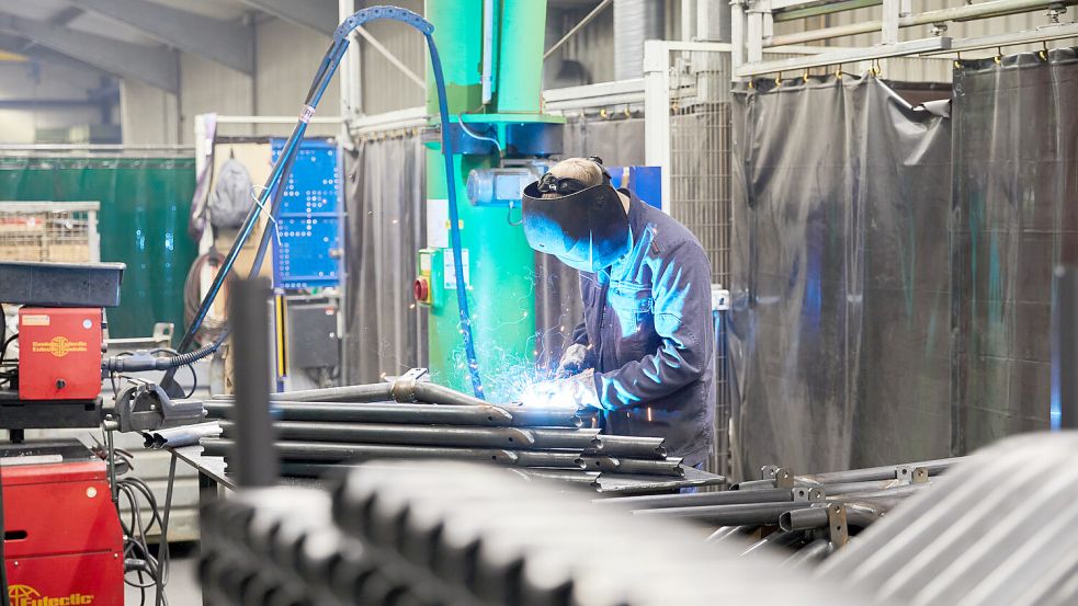 Funkenflug: Das Bild zeigt einen Mitarbeiter in der Produktionshalle beim Schweißen eines Trenngitters. Foto: Kollmer