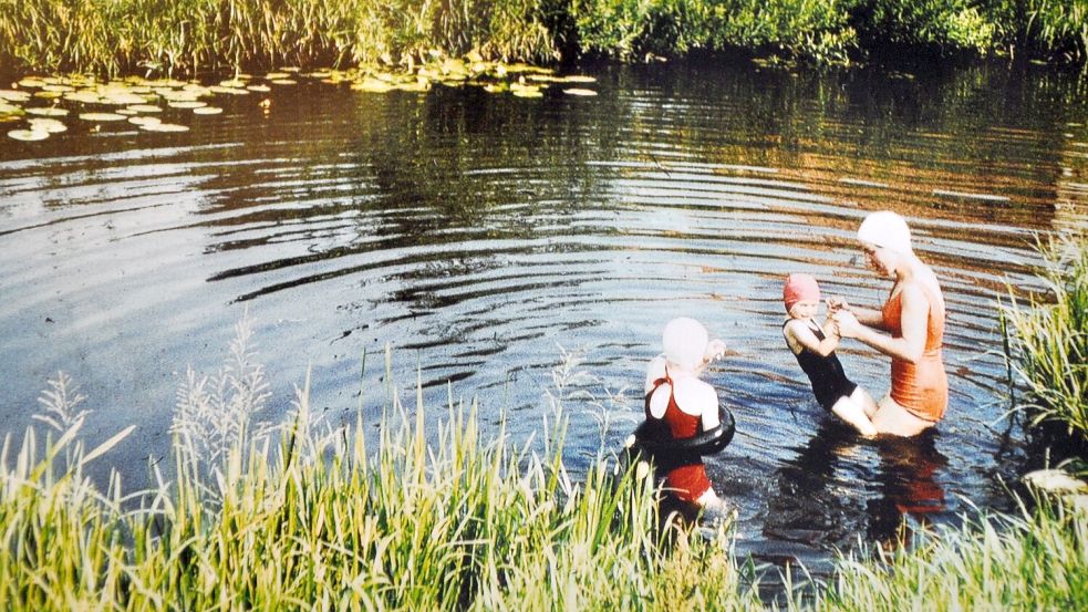 Der Kanal war vor 60 Jahren noch eine Lebensader Westgroßefehns. An heißen Tagen sprangen nicht nur die Kinder hier ins Wasser. Christa Kortmann-Titze (Mitte) plantscht mit einem Nachbarmädchen (links) und einem Feriengast. Foto: privat
