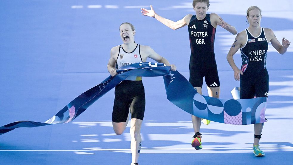 Der Zieleinlauf ins Glück: Laura Lindemann sichert den deutschen Triathleten Gold in der Mixed-Staffel. Foto: Marijan Murat/dpa