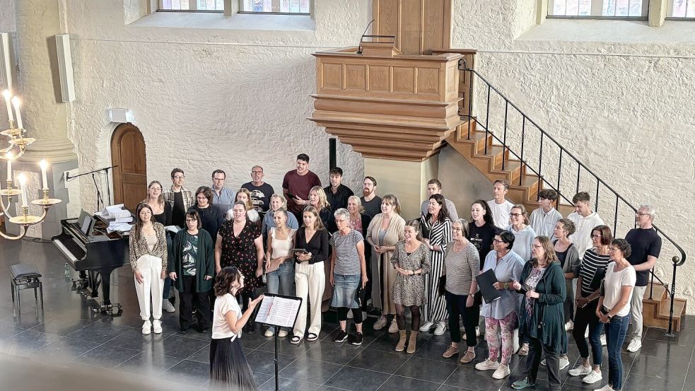 Chorleiterin Julia Grupe-Dörr (vorne am Notenständer) probt mit dem Chor Ligante und dem Vokalensemble Mixed Pickles für den erstmaligen gemeinsamen Auftritt. Fotos: Hanssen