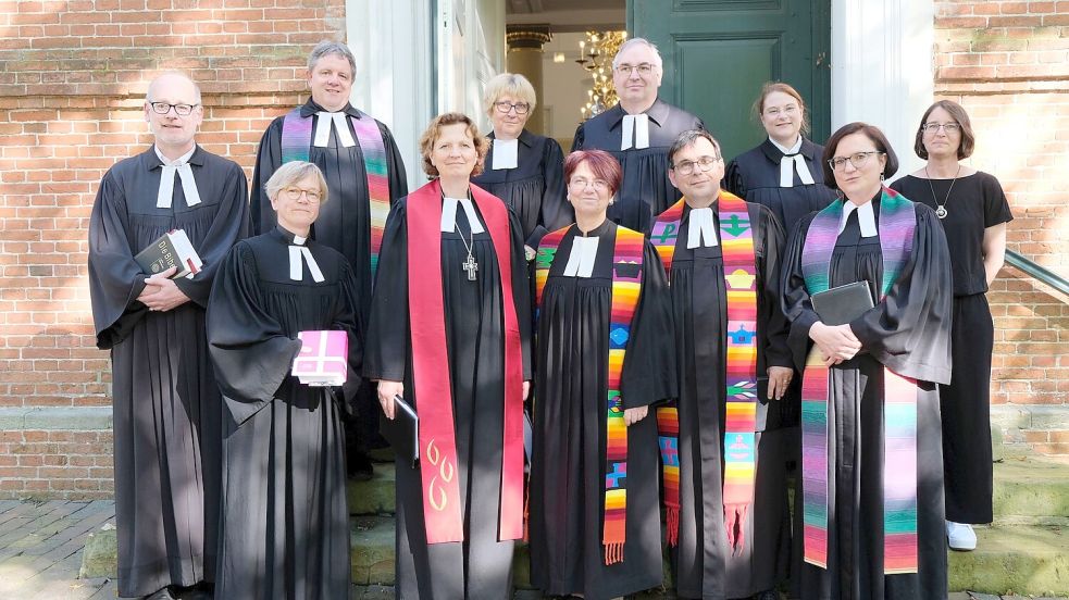 Regionalbischöfin Sabine Schiermeyer (roter Schal) und Oberkirchenrätin Dr. Michaela Veit-Engelmann (rechts) führten Pastorin Dr. Ruth Koßmann und Pastor Joachim Pothmann (Mitte, mit bunten Schals) in ihre Aufgaben ein. Mit dabei waren die Geistlichen (von links): Christoph Schoon aus Timmel, Superintendentin Eva Hadem aus Esens, Frank Karsten (Wiesens), Jutta Renken-Sprick, Andreas Scheepker und Sonja Skoczylas (alle ARO) sowie Christiane Schuster-Scholz aus Holtrop. Foto: privat