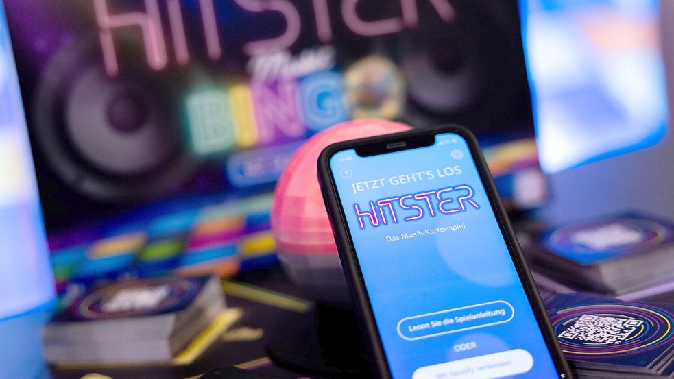 Die App spiel die Musik ein, die Spieler müssen danach die Karten sortieren: Hitster gilt als erfolgreiches Hybrid-Spiel. Foto: Rolf Vennenbernd/dpa