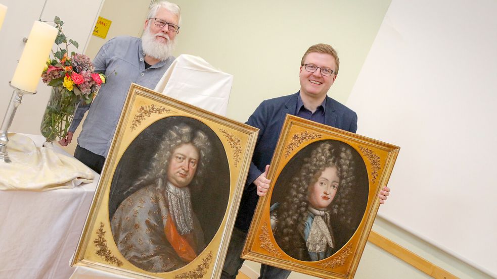 Harm Paul Schorpp aus Jork und Dr. Christopher Galler freuen sich, dass die beiden Gemälde zurück in Aurich sind. Foto: Romuald Banik