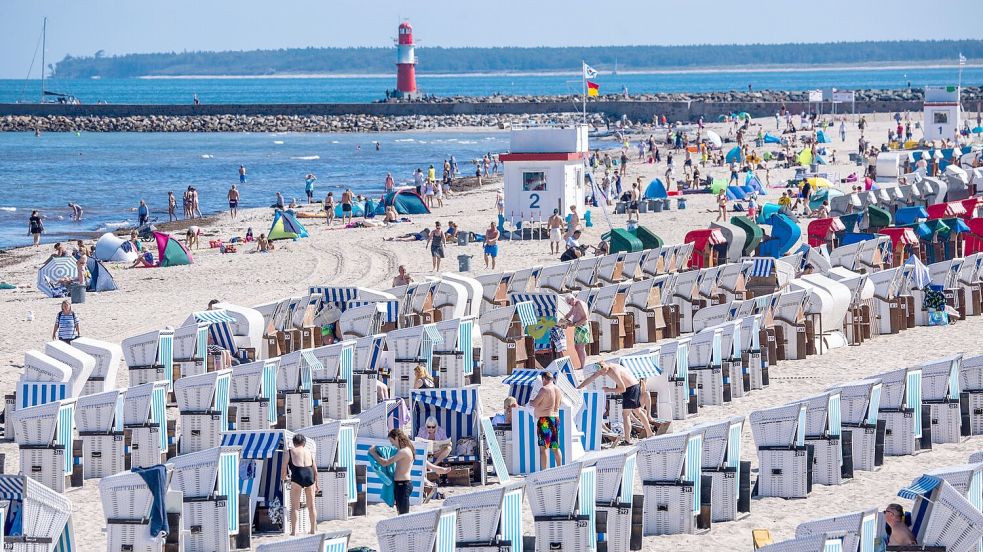 Sommerurlauber am Ostseestrand in Warnemünde. Im Zeitraum von Januar bis Oktober erzielte der Deutschland-Tourismus mit gut 433 Millionen Übernachtungen einen Rekord. Foto: Jens Büttner/dpa