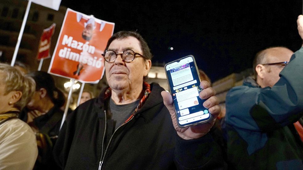 Ein Demonstrant zeigt das Warnungssystem auf seinem Handy während eines Protests gegen die lokale Regierung. Die Katastrophenwarnung kam wohl Stunden zu spät. Foto: dpa/Eduardo Manzana